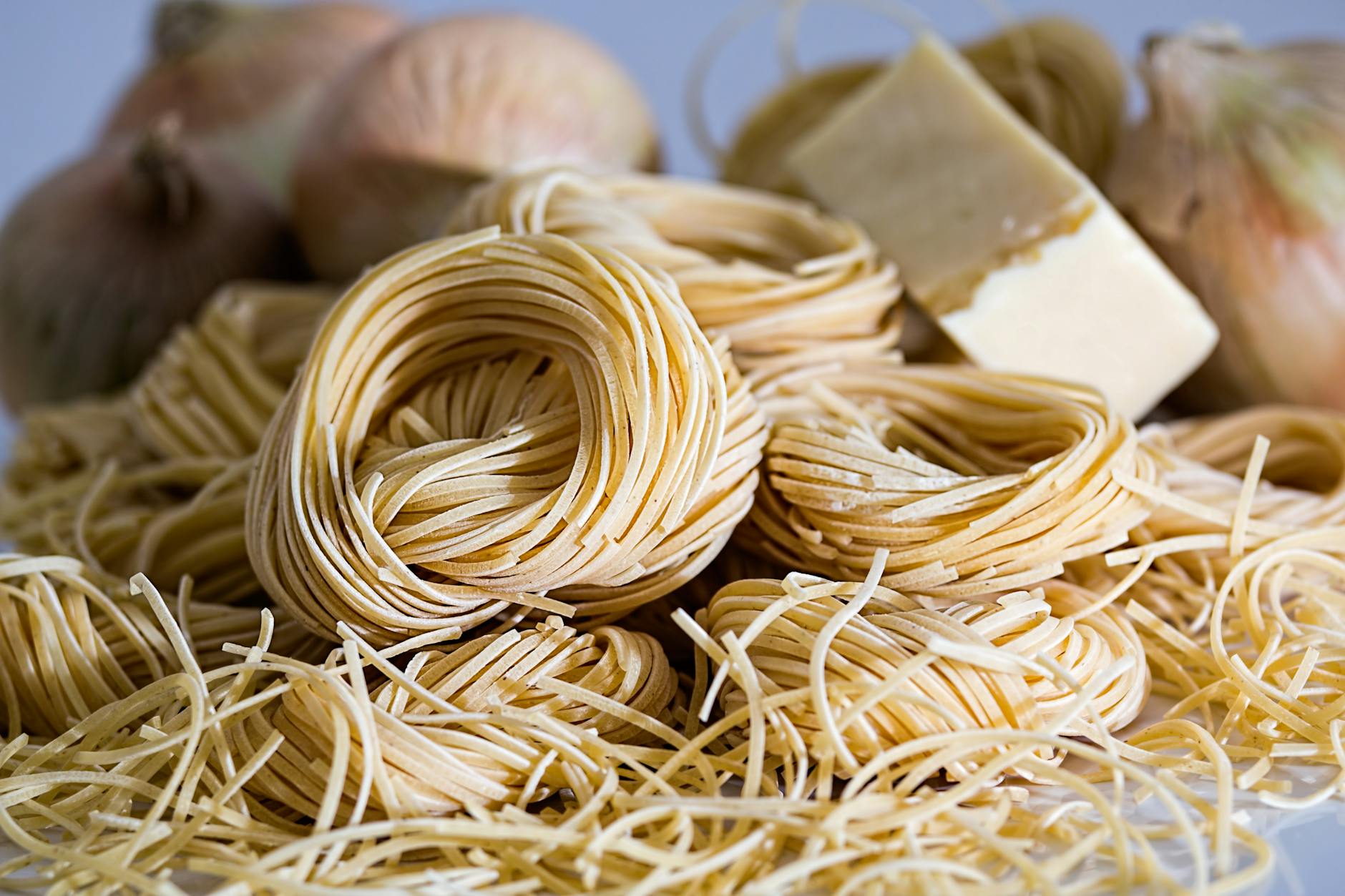 yellow pasta beside onions