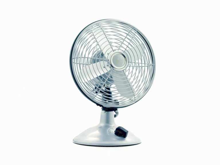 white desk fan on white table
