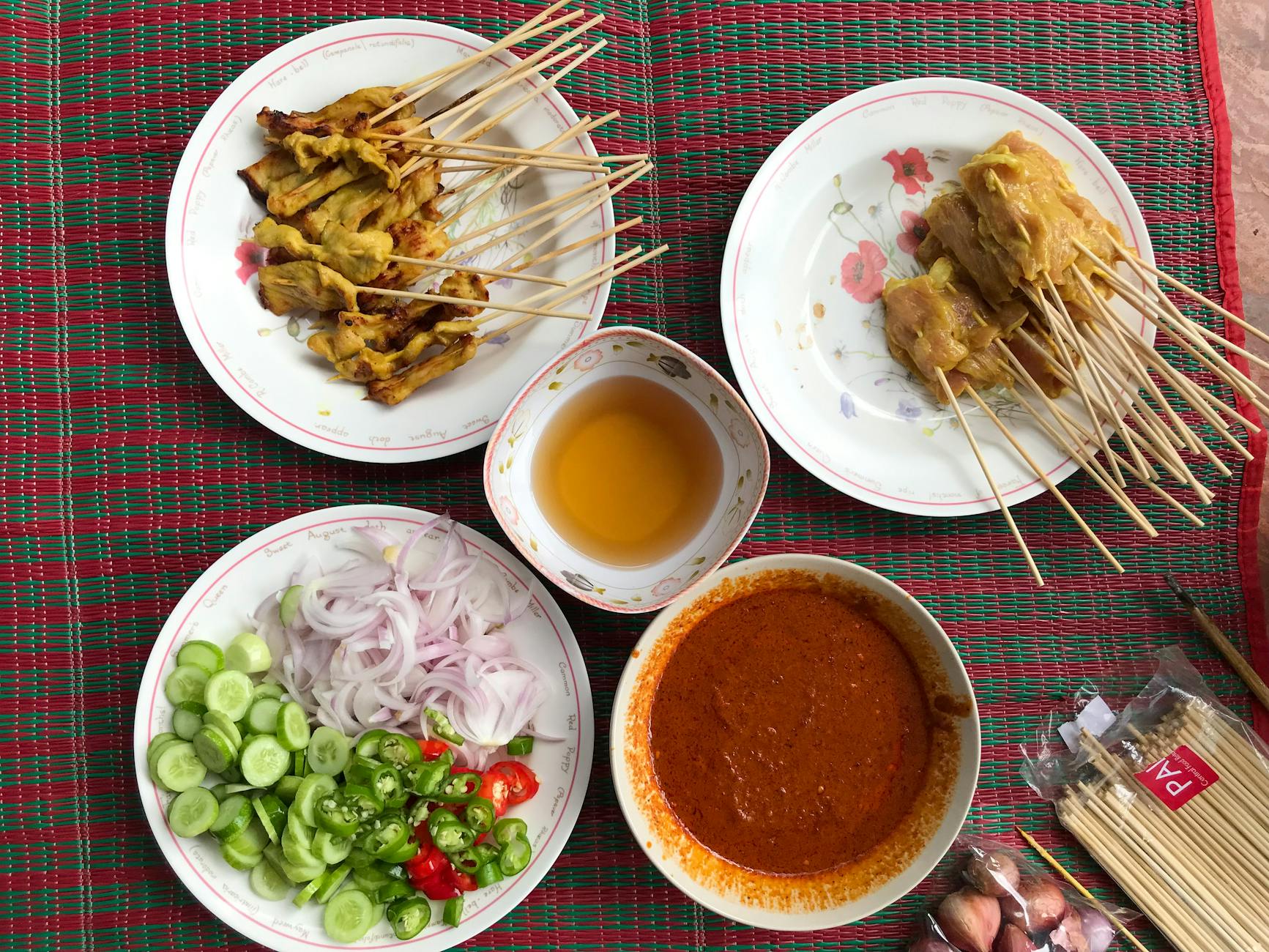 chicken satay with sauces and vegetables