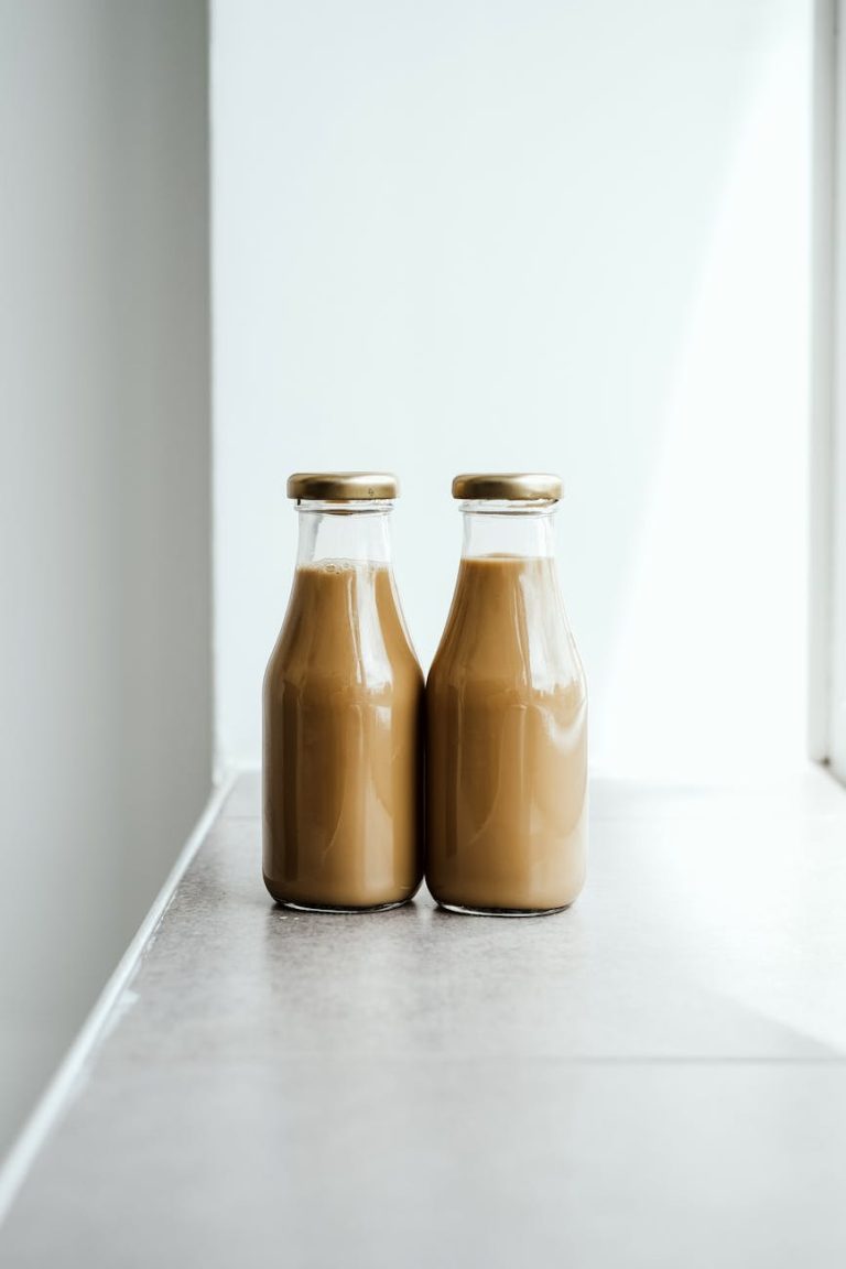 two chocolate drinks in glass bottles