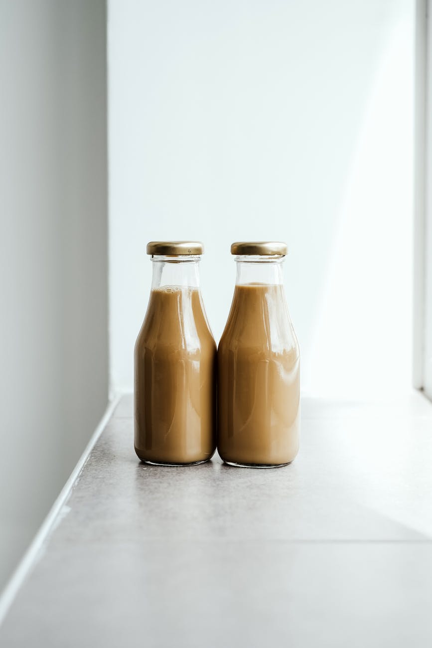 two chocolate drinks in glass bottles